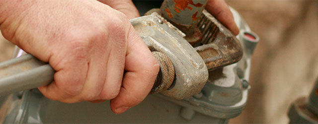 Plumber with wrench and pipe